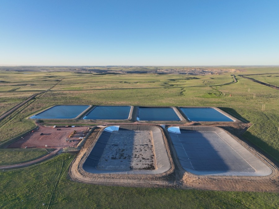 Aerial view of the Talon water facility showing four filled reservoir cells and two newly lined cells on open grassland